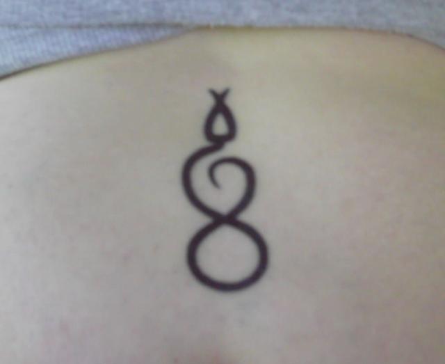 Jody's lower back tribal snake tattoo